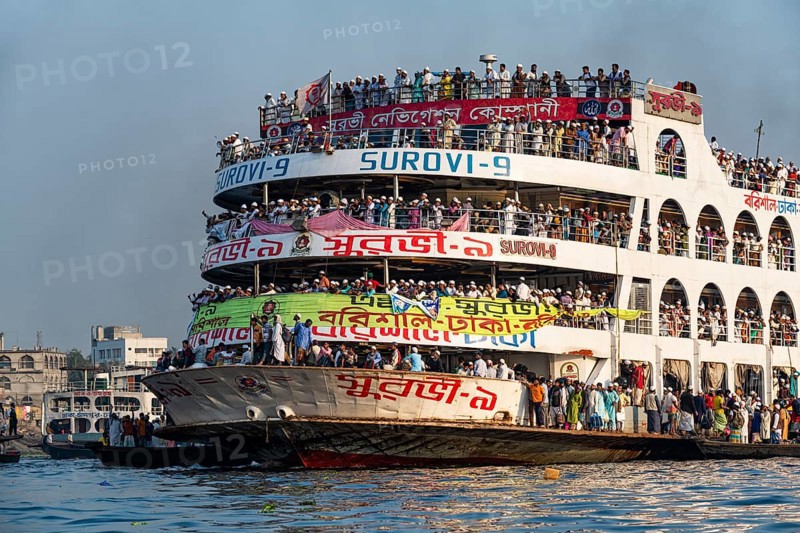 Overloaded passenger ferry with pilgrims on the Dhaka river