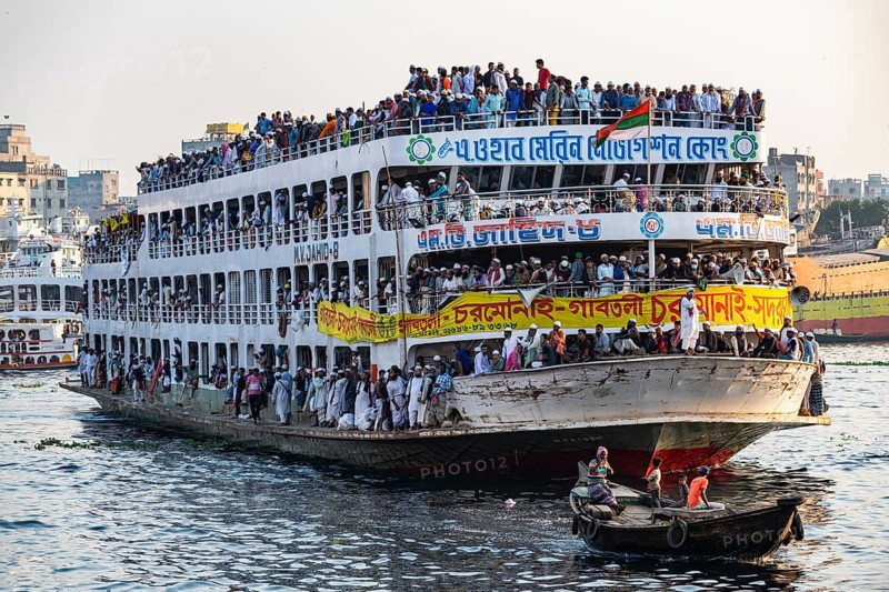 Overloaded passenger ferry with pilgrims on the Dhaka river