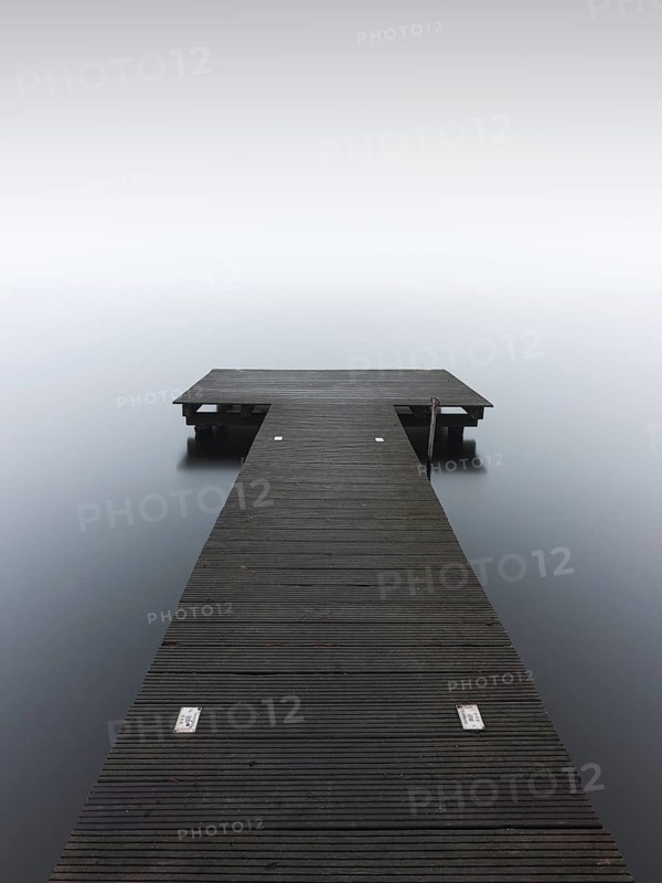 A jetty in dense fog in the Kleiner Schwielochsee
