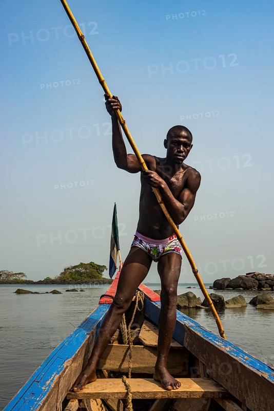 Man pushing his small boat on Banana islands