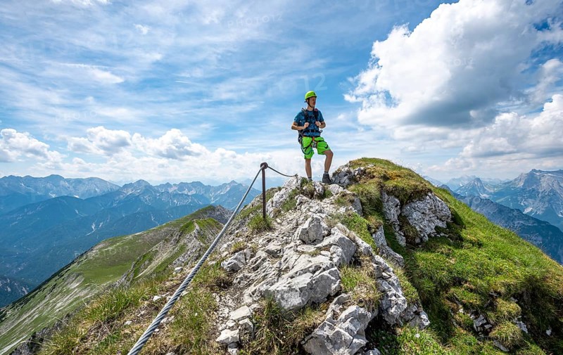 Mountaineer on a ridge on a secured fixed rope route