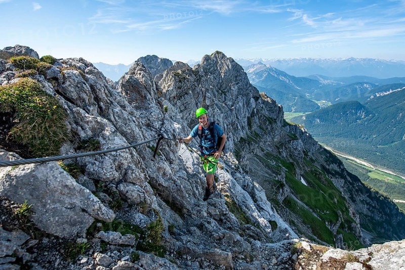 Mountaineer climbs on a secured fixed rope route