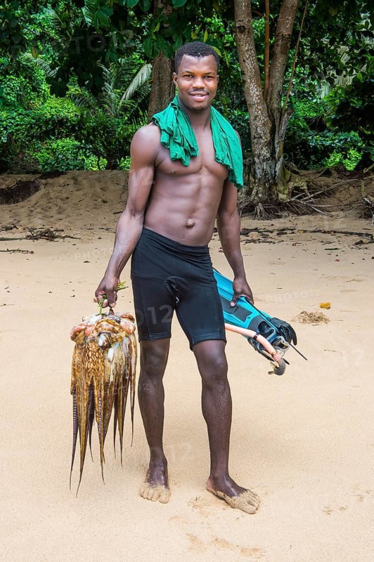 Man presenting his fresh caught squid