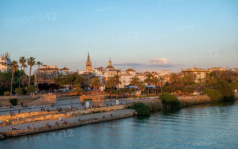 Waterfront Muelle de la sal at the river Rio Guadalquivir with Monumento a la Tolerancia
