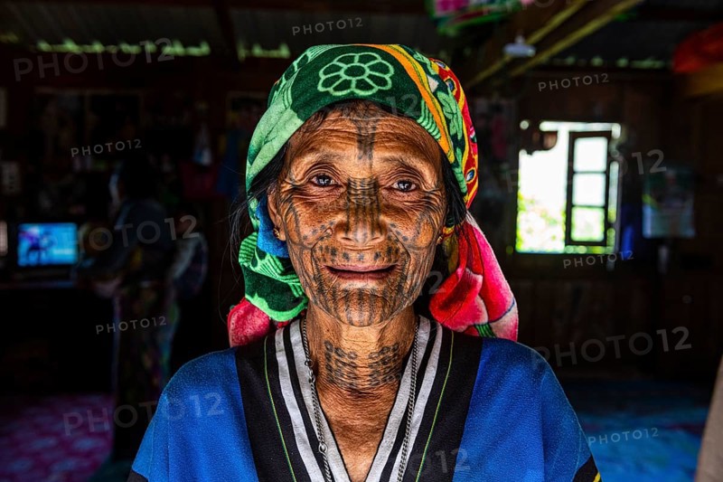 Chin woman with spiderweb tattoo