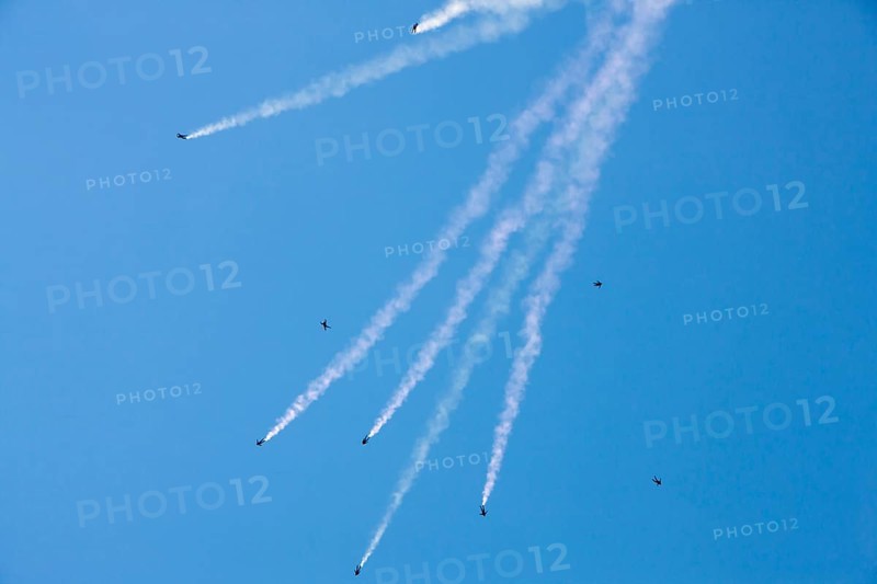 Parachutes in free fall with a smoke trail