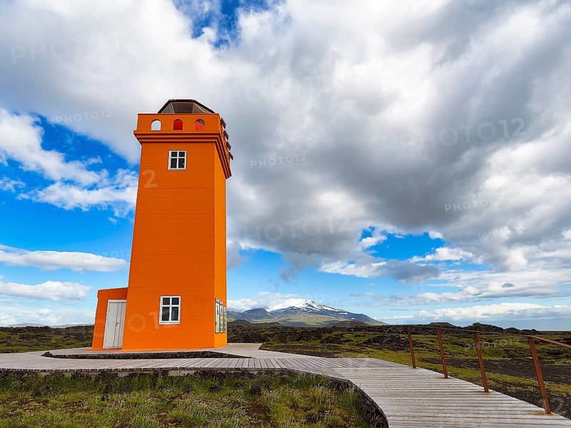 Orange lighthouse Skalasnagaviti or Svoertuloft with wooden boardwalk