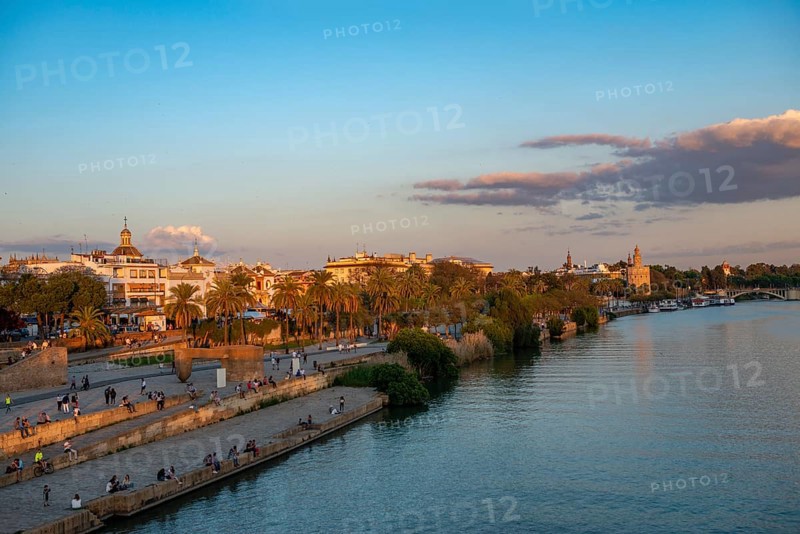 Waterfront Muelle de la sal at the river Rio Guadalquivir with Monumento a la Tolerancia