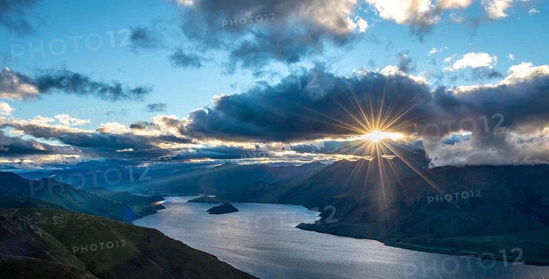 Last rays of sun shining through cloudy sky