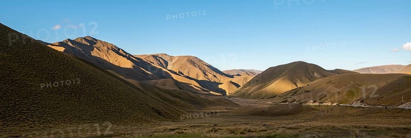 Barren mountain landscape with tufts of grass
