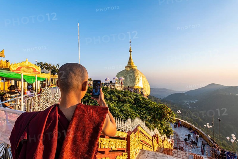 Monk photographing the Kyaiktiyo Pagoda