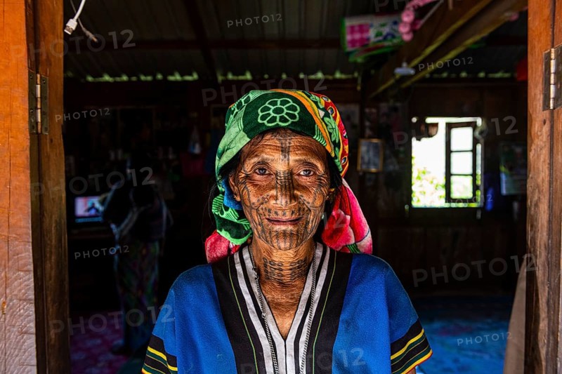 Chin woman with spiderweb tattoo