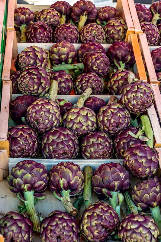 Crate of artichokes on a market stale
