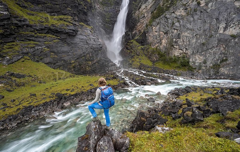 Hiker standing by river Driva