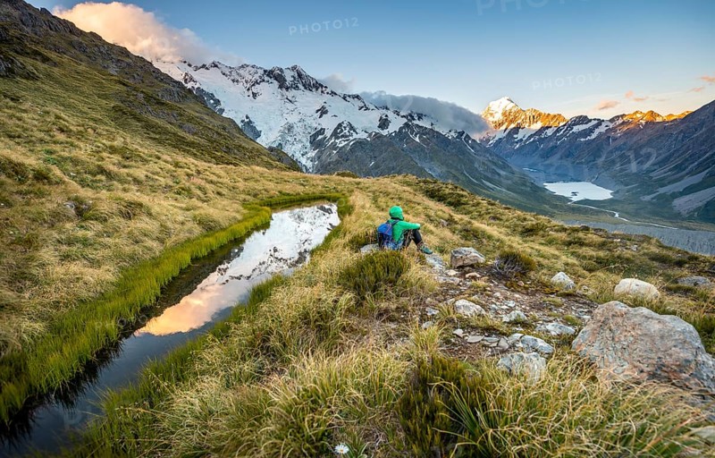 Hiker sitting at a mountain lake