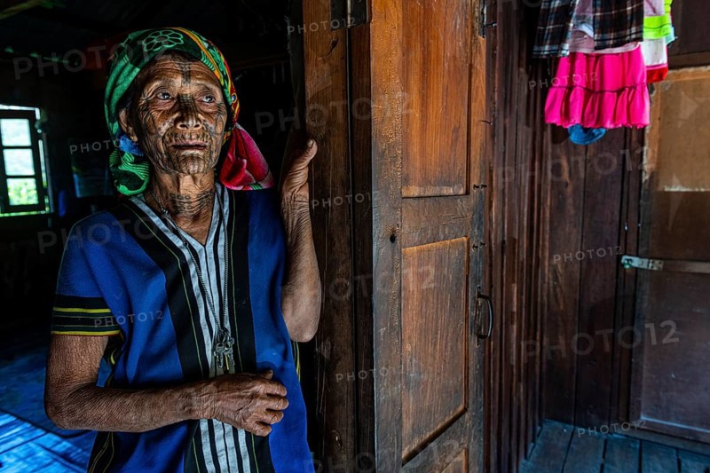 Chin woman with spiderweb tattoo
