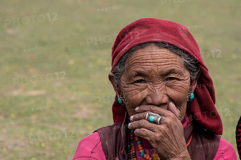 Portrait of an elderly woman with turquoise earring and finger ring