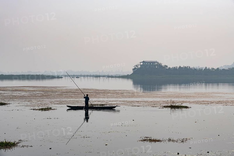 Fisherman in his canoe fishing