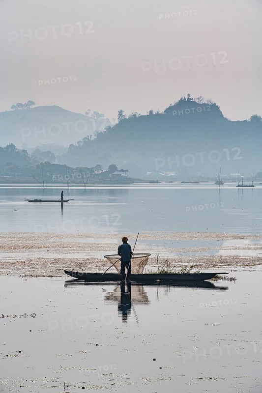 Fisherman in his canoe fishing