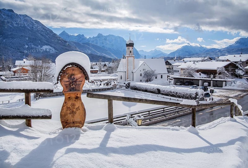 Village view with parish church and Karwendel mountains