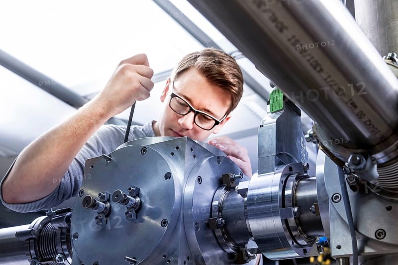 PhD student during his research work adjusting his experimental setup