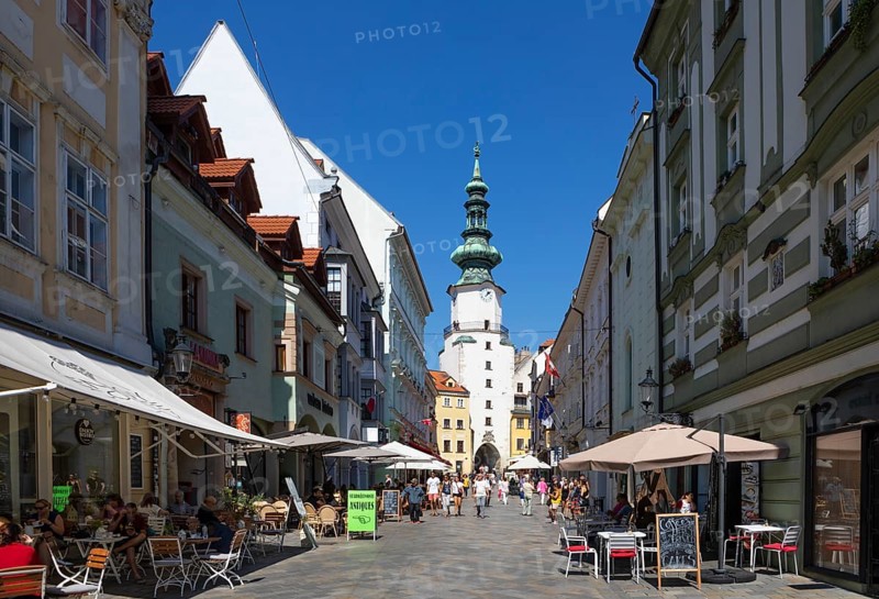 Pedestrian zone with restaurants in Michalska Street with Michael's Gate