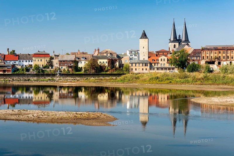 Old town with witch tower and Stephani church reflected in the river Saale