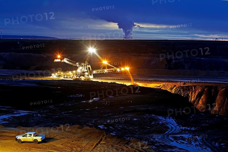 Opencast lignite mine with stacker in the evening