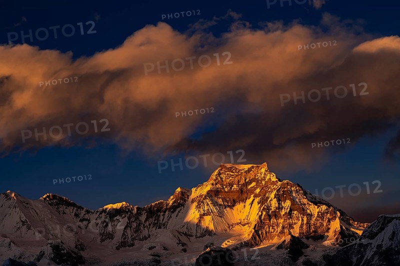 View in the evening light from Renjo La Pass 5417 m to the east on Himalaya with Gyachung Kang