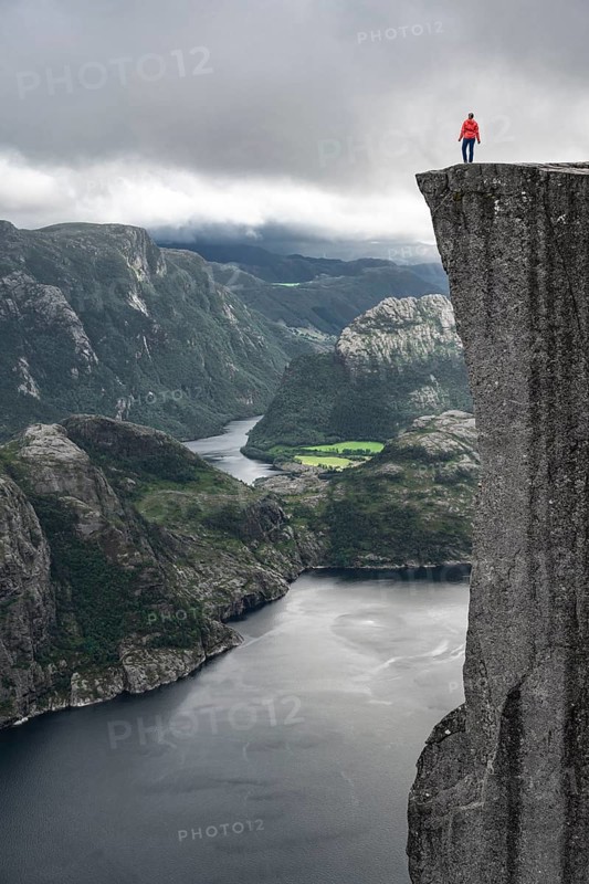 Person standing on steep cliff