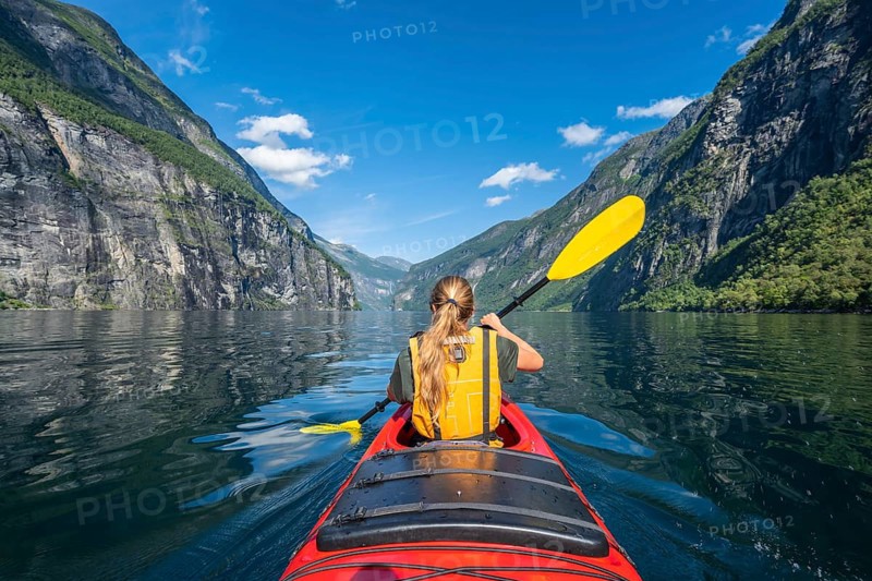 Young woman paddling in a kayak