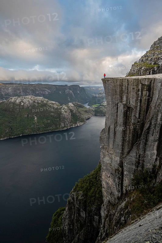 Person standing on steep cliff