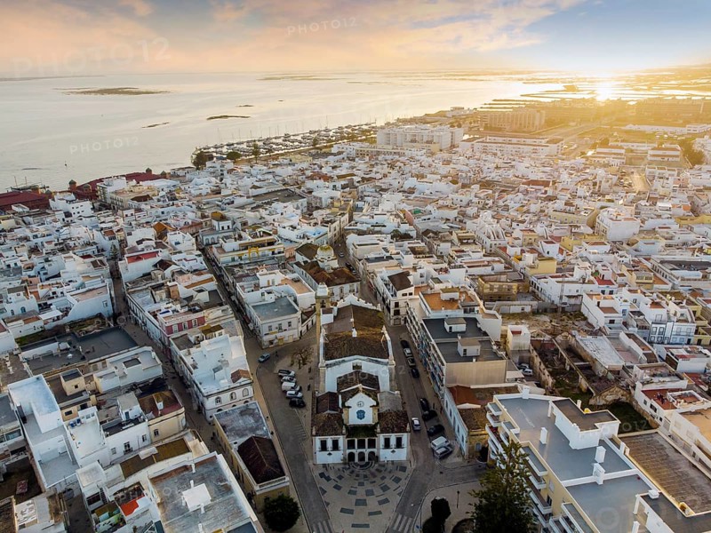 Aerial view of Olhao with a church in the foreground by sunset