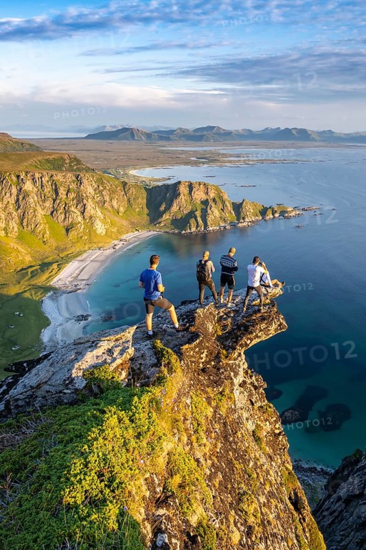 Four hikers standing on rocky outcrop
