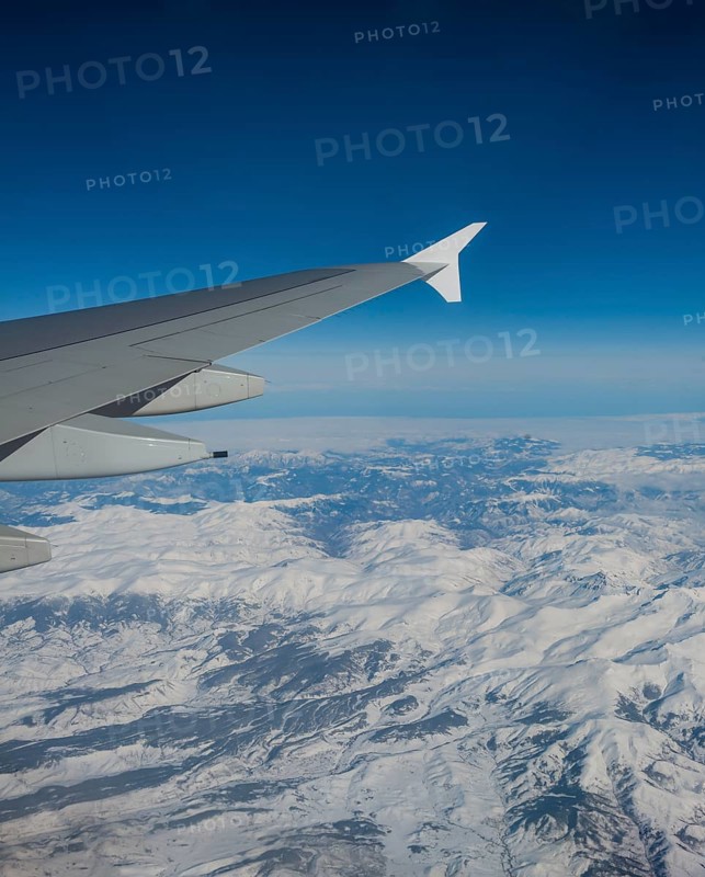 View of mountains and snowy landscape from the airplane