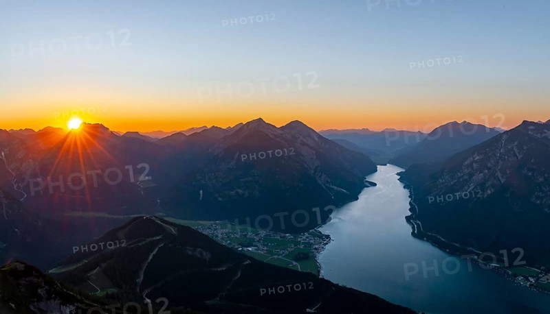 Last rays of sun over mountain landscape at sunset