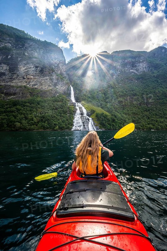 Young woman paddling in a kayak