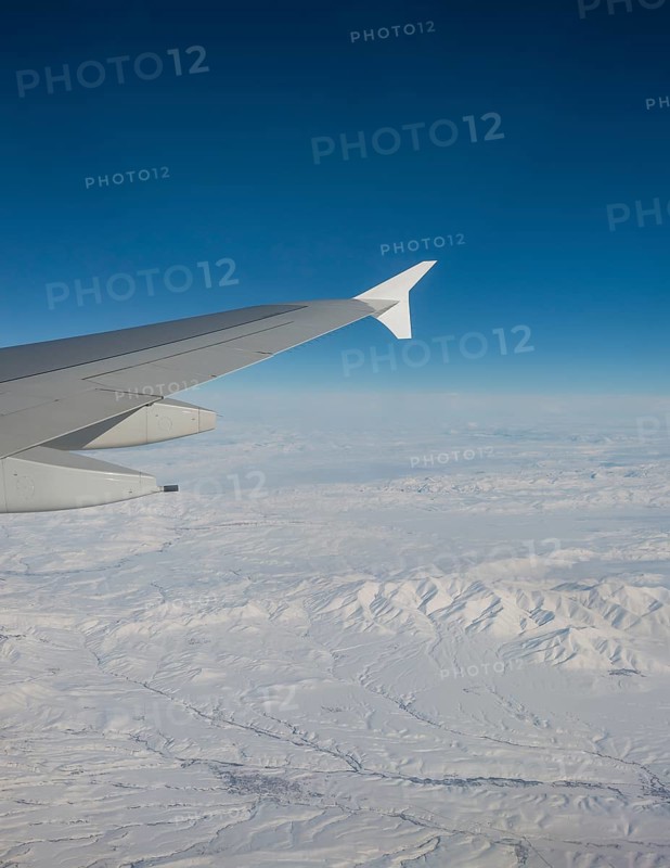 View of mountains and snowy landscape from the airplane