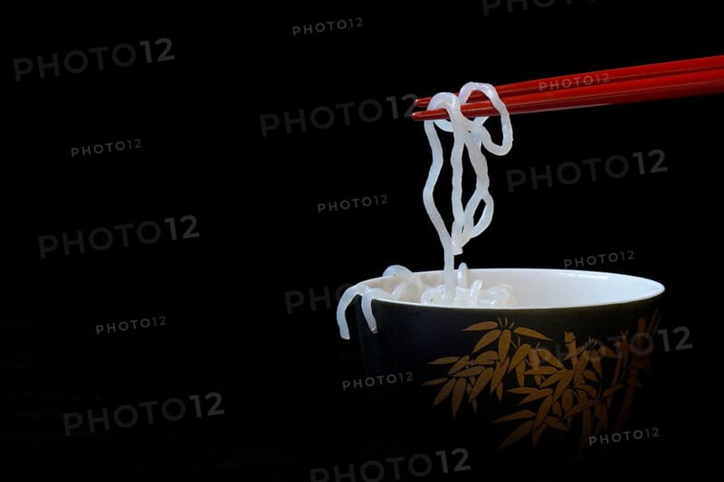 Shirataki noodles made from konjac flour on chopsticks