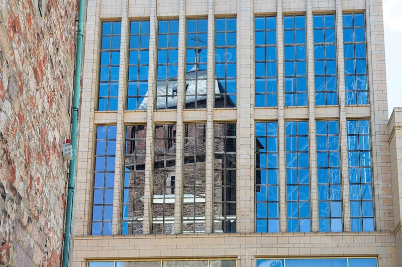 Reflection of the Red Tower in the glass facade of the Galerie Roter Turm