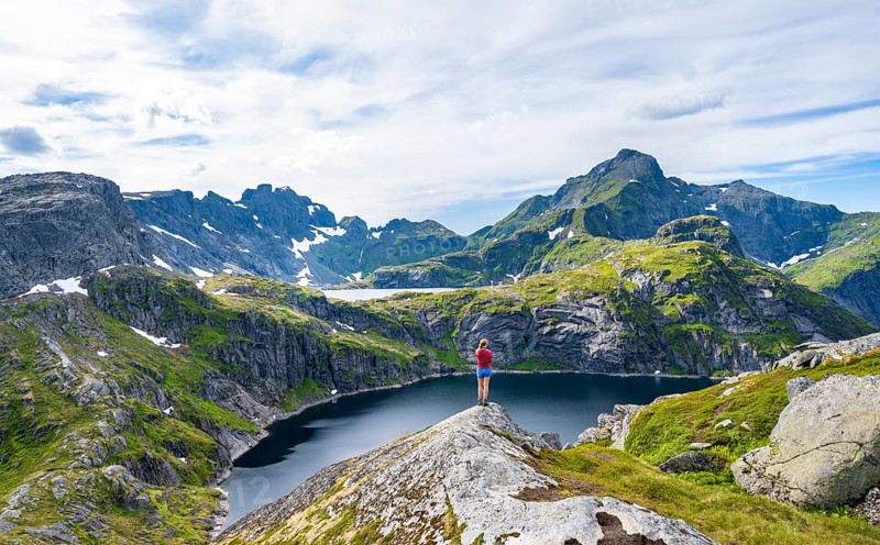 Hiker looking over lake Tennesvatnet