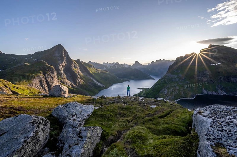 Young woman looking over fjord landscape
