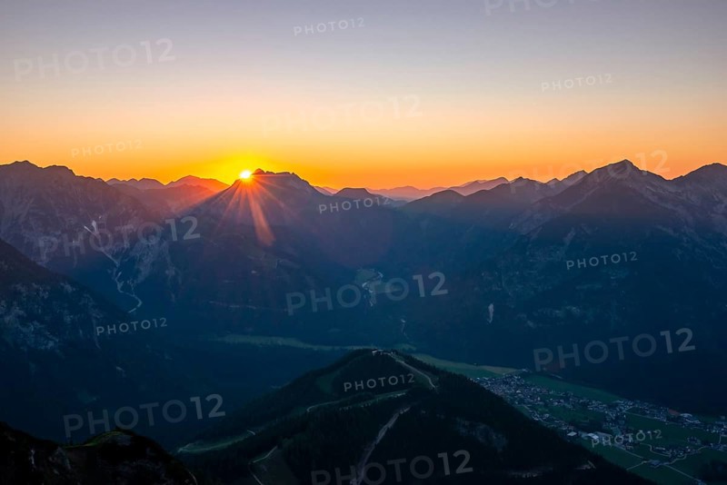 Last rays of sun over mountain landscape at sunset