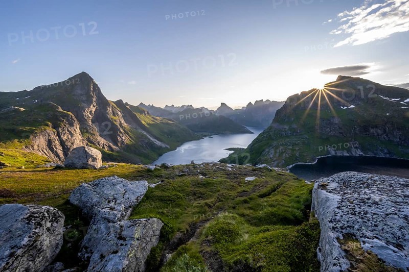 Sun shines over mountain landscape with fjord Forsfjorden and lake Krokvatnet