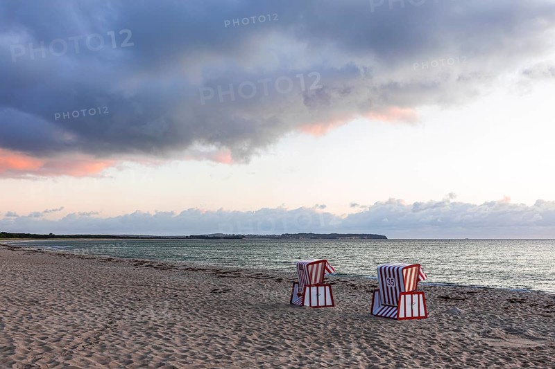 Lonely beach chairs in the morning light at the big beach of Thiessow