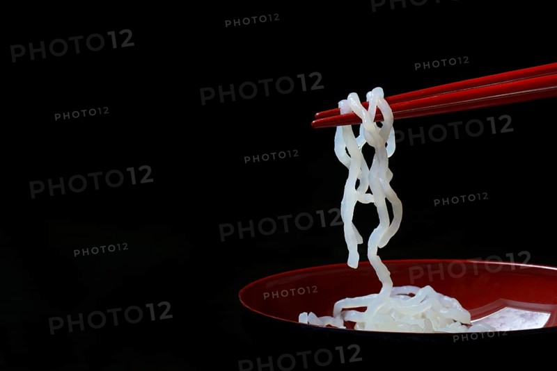 Shirataki noodles made from konjac flour on chopsticks
