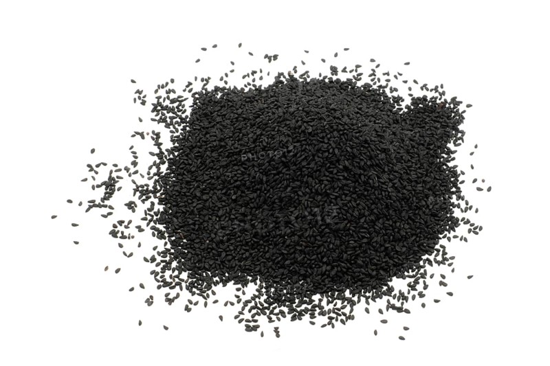 Nigella seeds against a white background