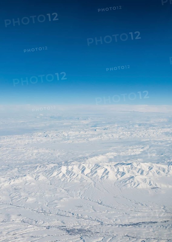 View of mountains and snowy landscape from the airplane