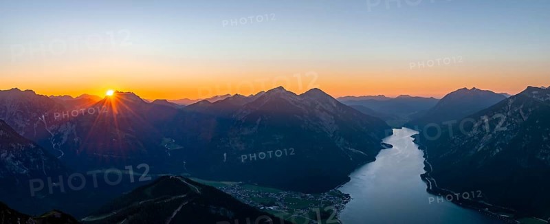 Last rays of sun over mountain landscape at sunset