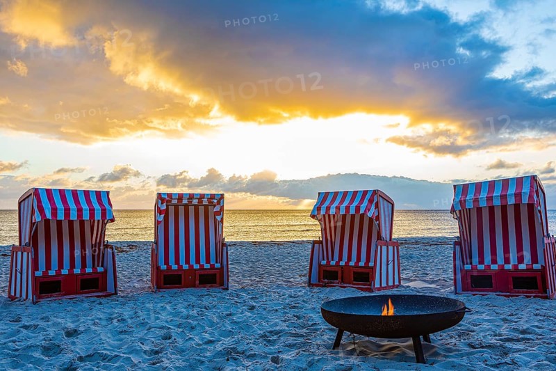 Beach chairs and fire bowl at sunrise at the big beach of Thiessow